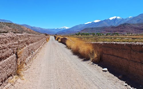 Calle de acceso entre muros de adobe  a \"La Poma Vieja\" con vista del \"Nevado de Acay\" y al nevado \"San Miguel\"  \"Cordillera de los Andes\"  \"La Poma\" \"Salta\" \"Arg\"   